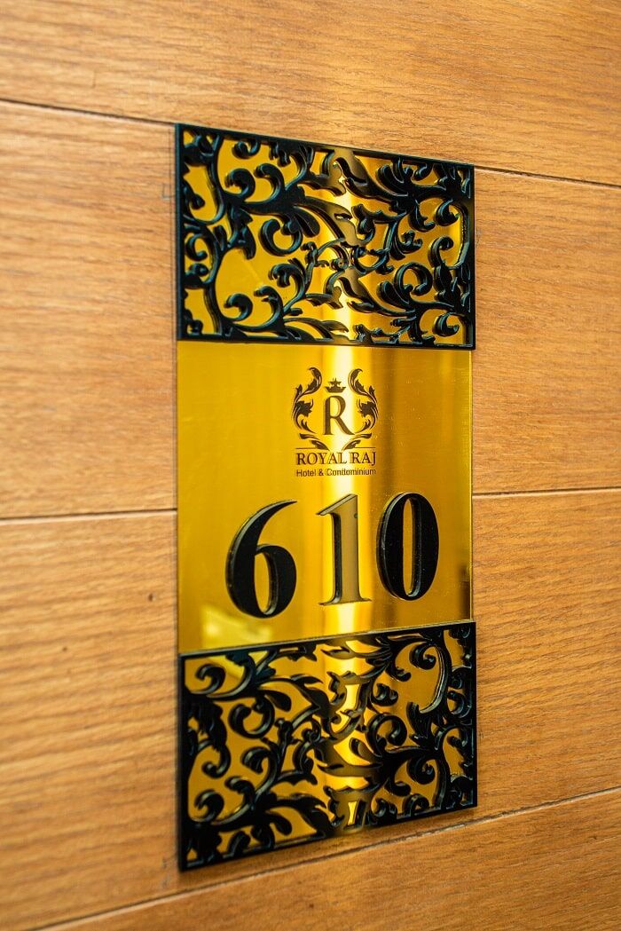 A gold and black door plaque for room 610.