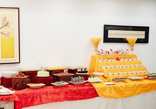 Cakes and pastries arranged on a bakery display counter.
