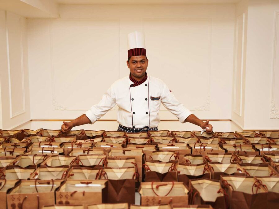 Catering team plating a buffet service at an outside event.
