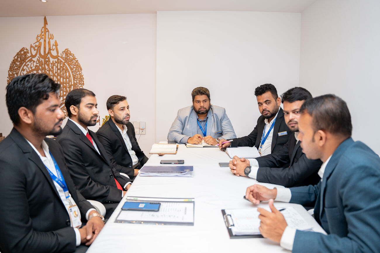 A meeting underway around the long table in the private meeting room.