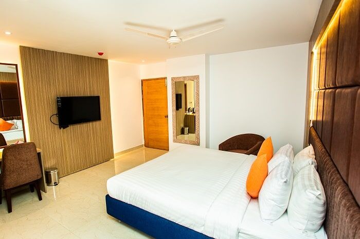 The Royal Suite, king bed on a raised base with panelled walls.