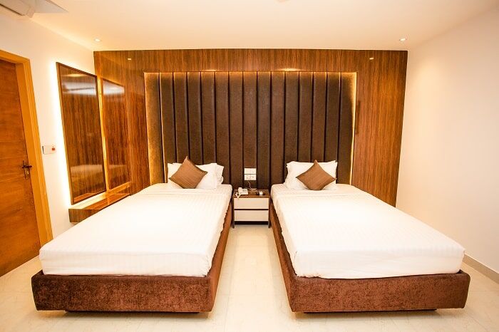 Superior Twin room with two single beds and a slatted wood wall.